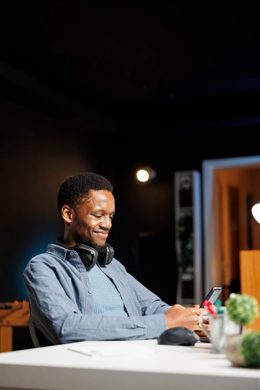 A business owner smiling while replying to a customer email